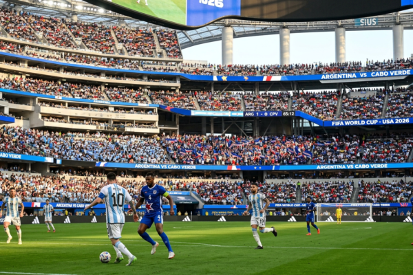 Soccer players from Argentina and Cabo Verde on the field during FIFA World Cup 2026 match with crowd and scoreboard in stadium
